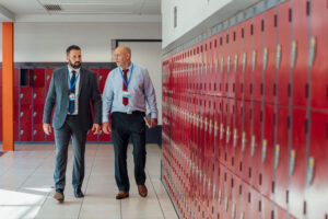 principal and colleague walking halls